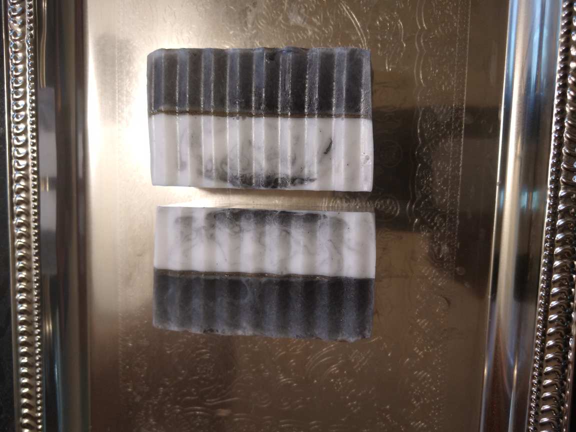 handmade organic creamy goat's milk and activated charcoal soaps for gently detoxed and moisturized skin for entire family