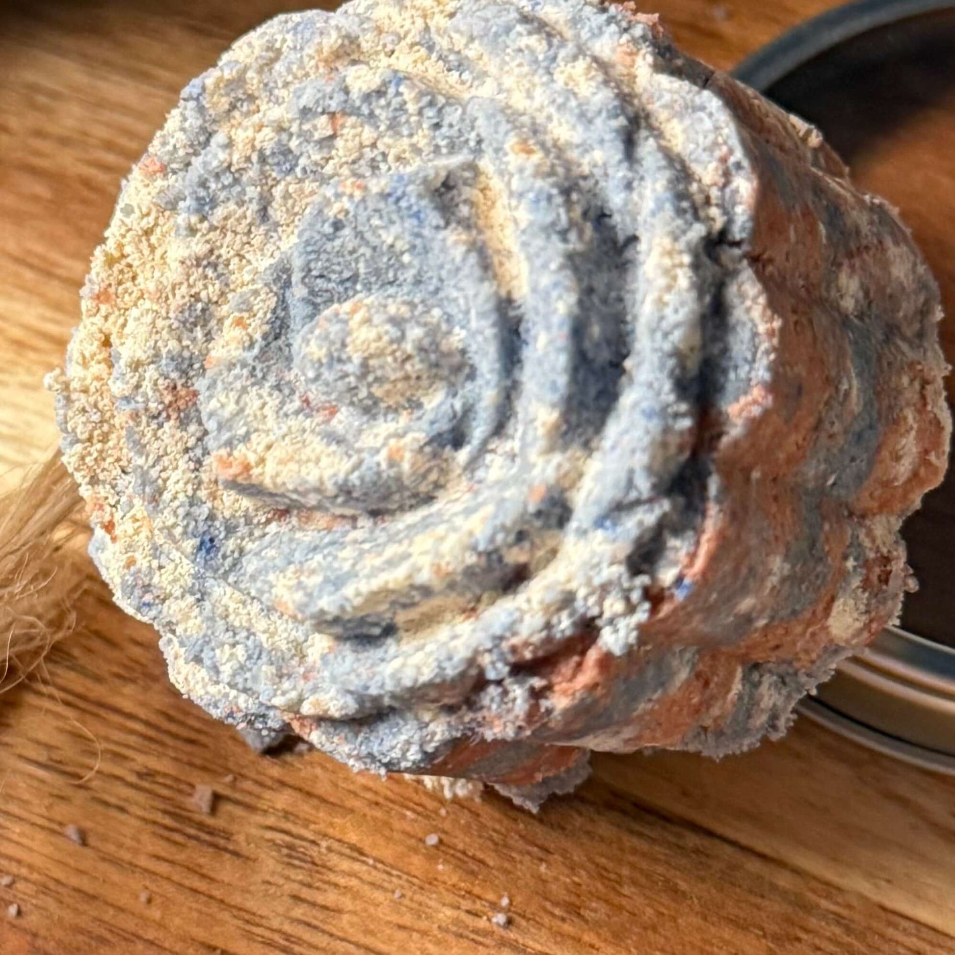 handmade organic small sized bath bombs with intricate molded patterns such as flowers and linear designs of pure ingredients