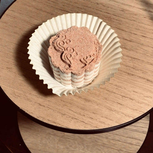 handmade organic small sized bath bombs with intricate molded patterns such as flowers and linear designs of pure ingredients