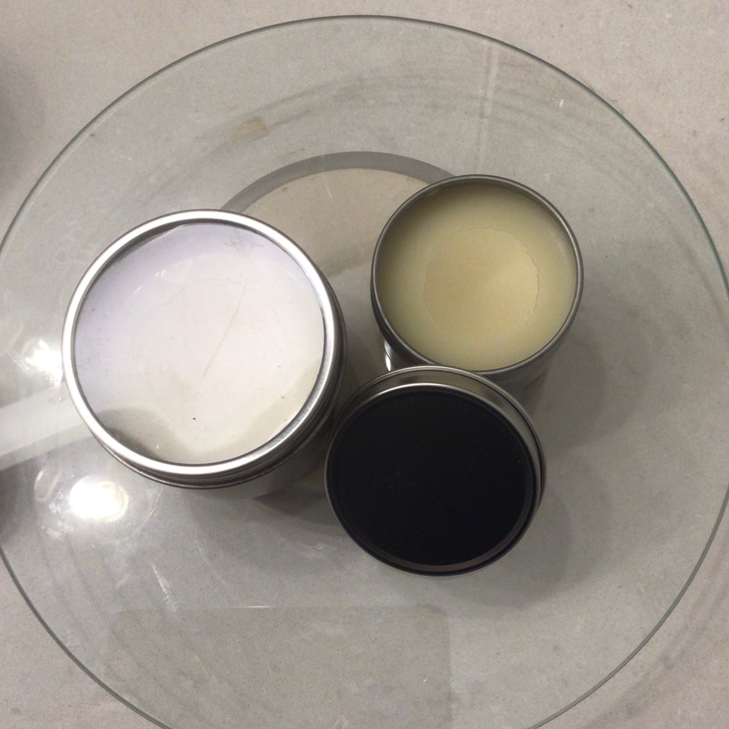 Handcrafted Soaps by SynEb Hand & Skin Armor 2oz and 4oz tins open on glass plate