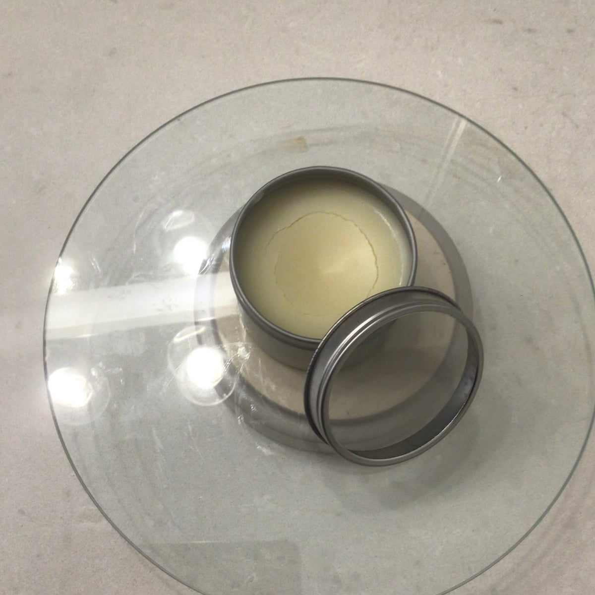 Handcrafted Soaps by SynEb Hand & Skin Armor 4oz tin open with lid beside it