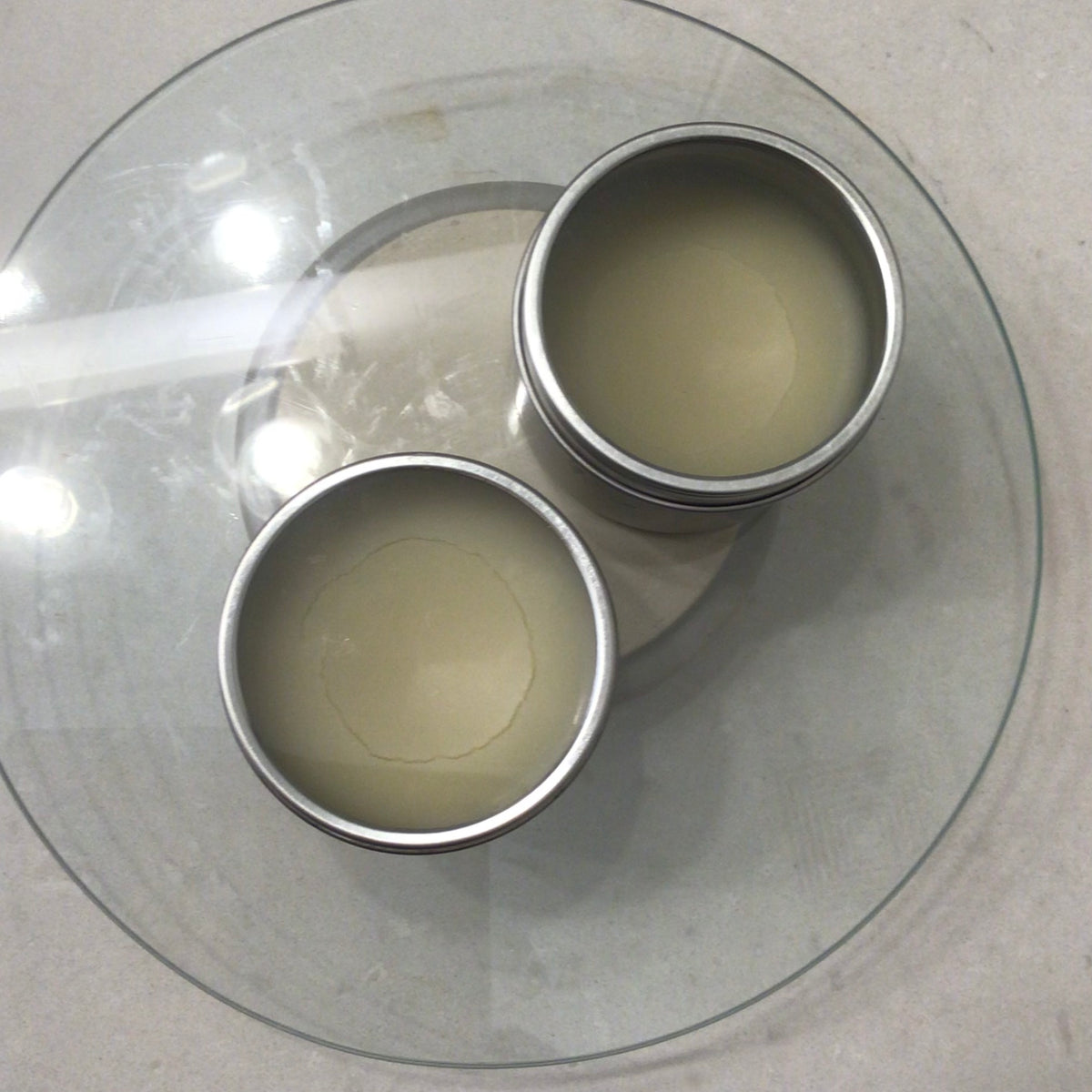 Handcrafted Soaps by SynEb Hand & Skin Armor two 4oz tins open on glass plate
