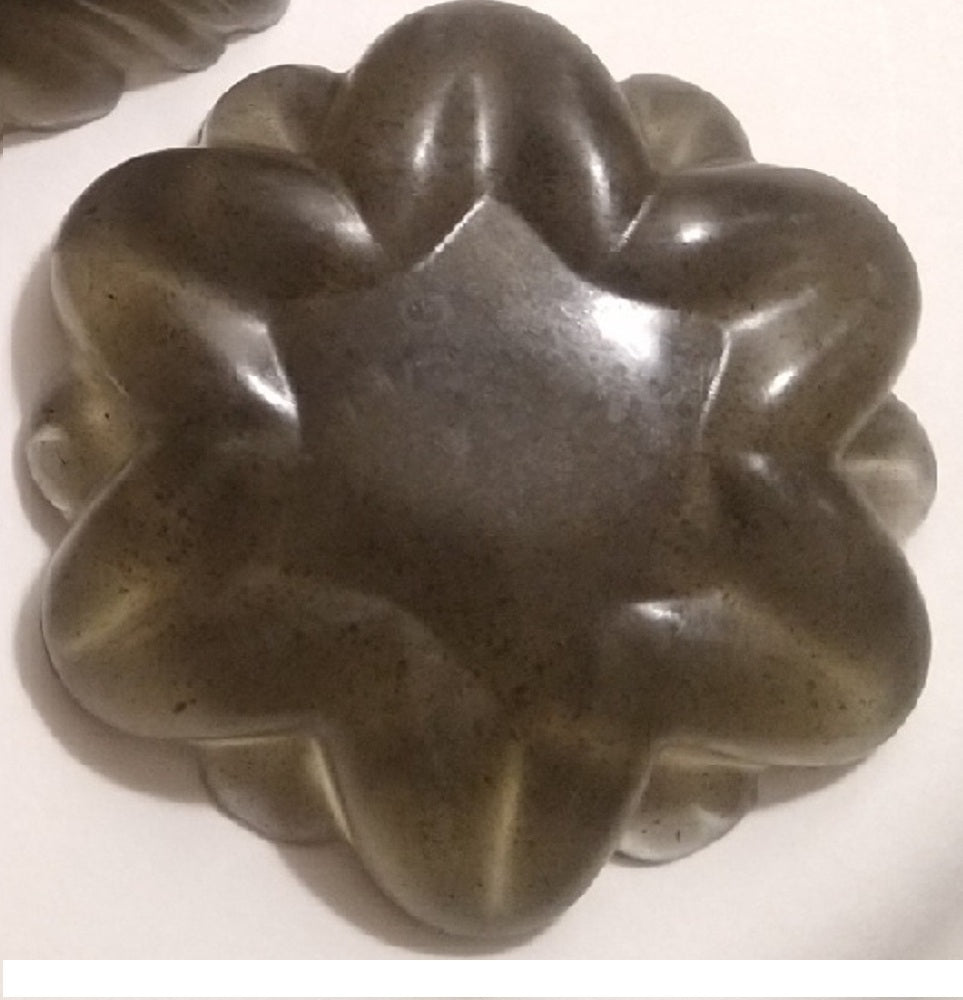 dark activated charcoal bar with large rounded petals and a wide flat center