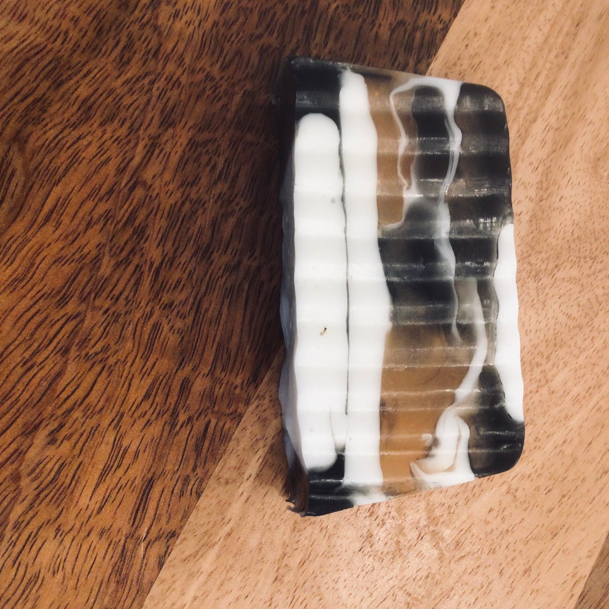 Handcrafted Soaps by SynEb Goats Milk Activated Charcoal Bar - single bar close-up showing black and white swirl