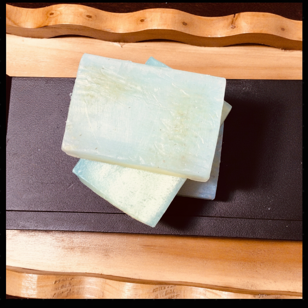 Handcrafted Soaps by SynEb Organic Exfoliating Glycerin Bars in mint stacked on a dark wood tray — loofah fruit soap