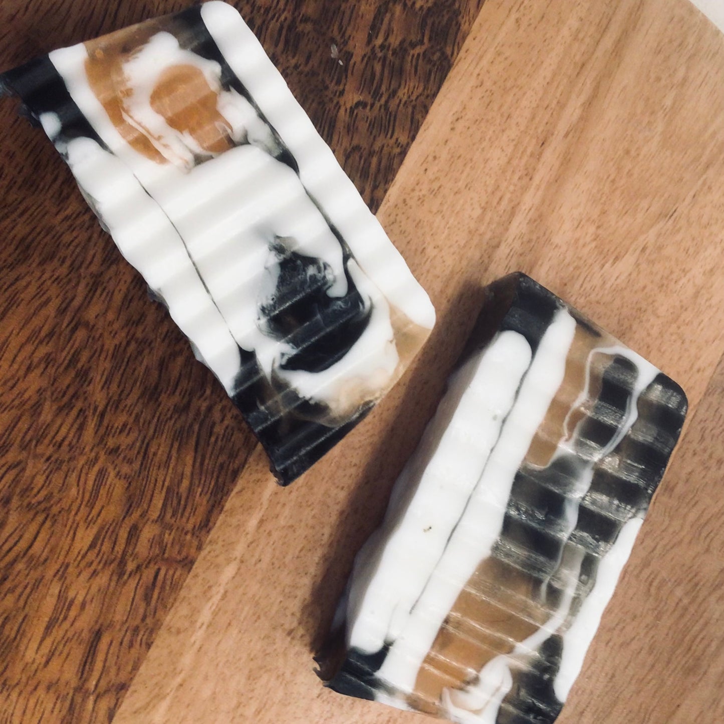 Handcrafted Soaps by SynEb Goats Milk Activated Charcoal Bar - two bars side by side on wood surface